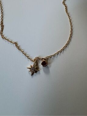 Gold Star Charm Necklace with Red Gem